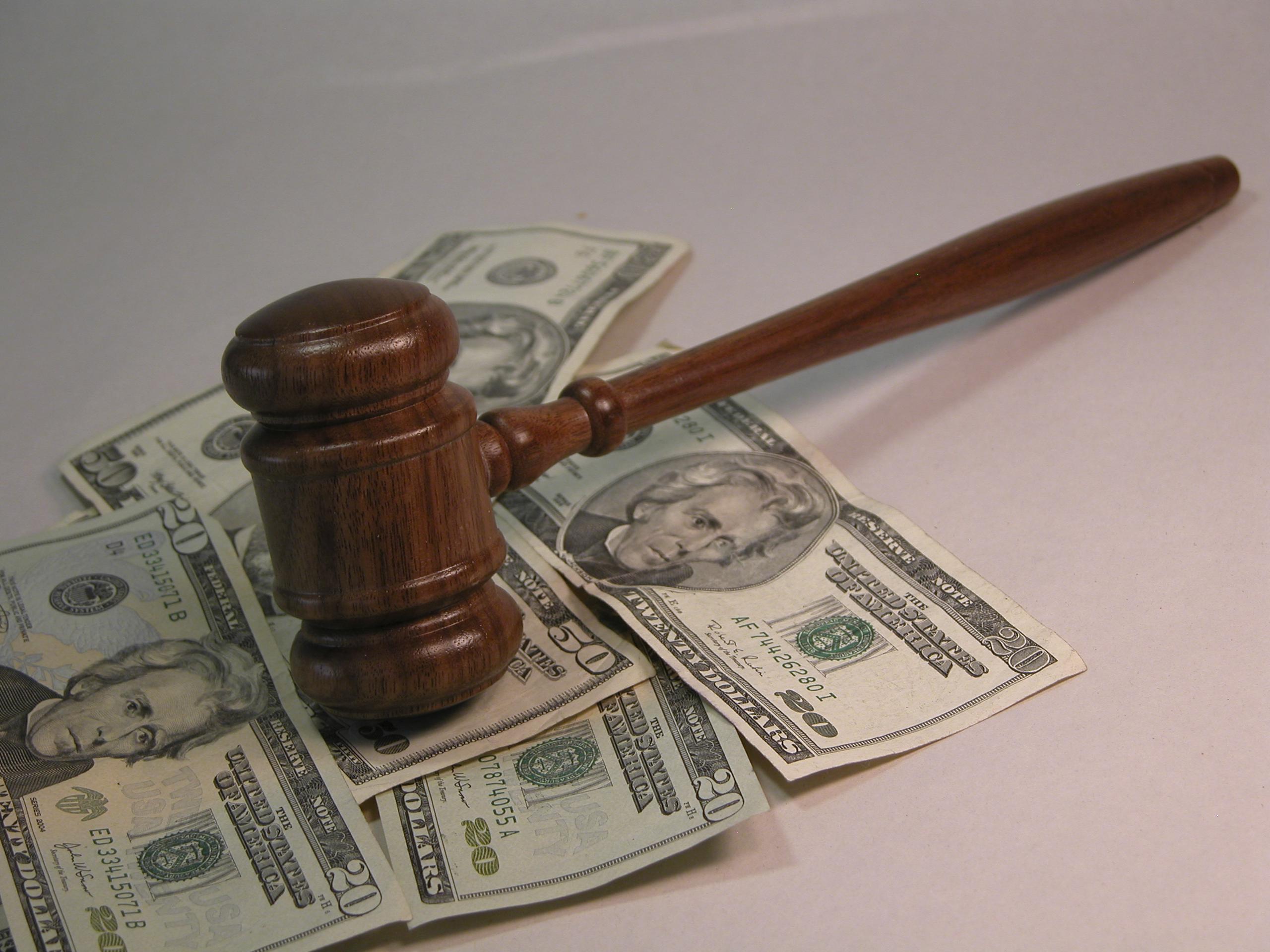 Gavel on top of cash