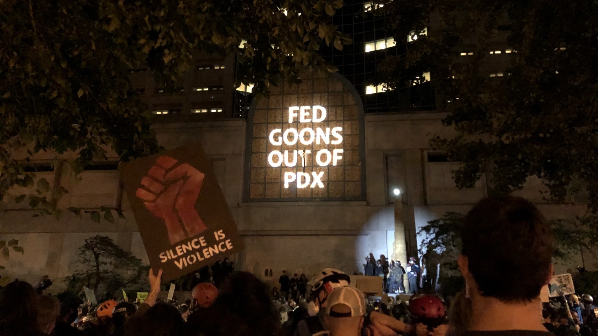 "Fed Goons Out Of PDX" projected onto the front of the Portland Justice Center.