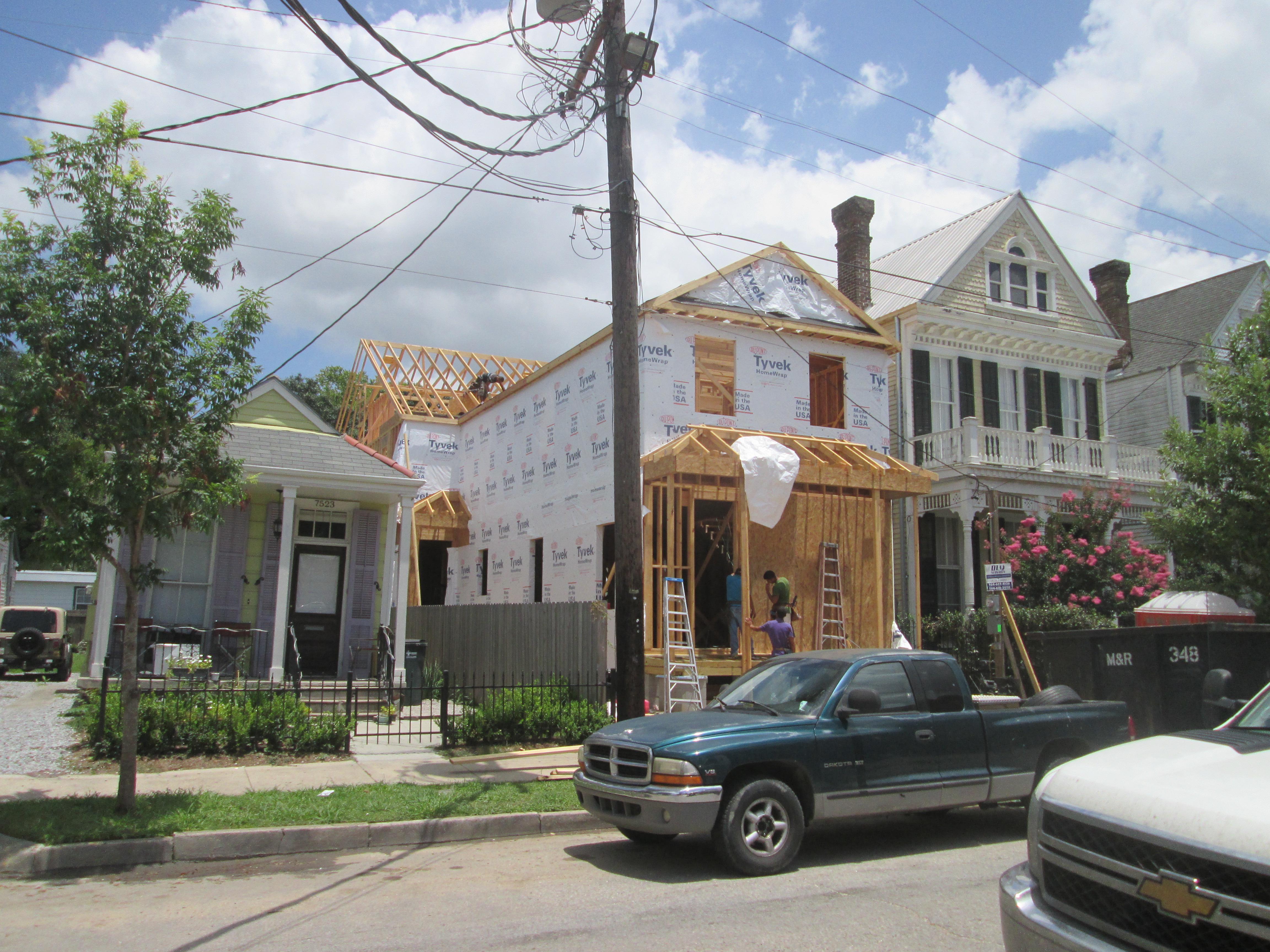 A house under construction with a pickup truck in front