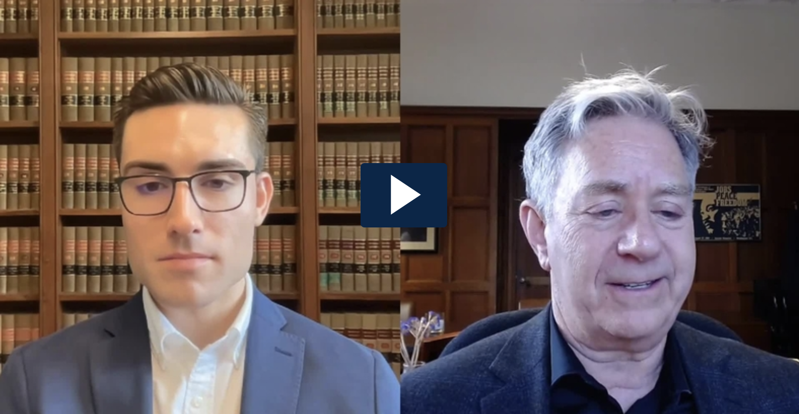 A split screen with 2L Andrew Eslich (left ) and Professor Michael Steinberg (right). A blue square with a white "play" button is between them.