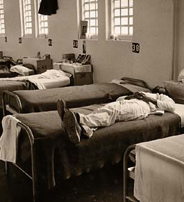 Male prisoner lies on infirmary bed
